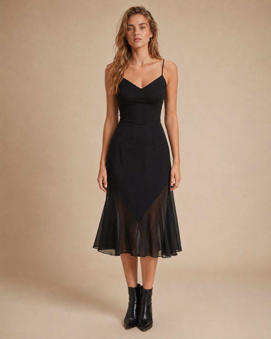 Woman wearing a black Vintemod dress in a neutral studio setting